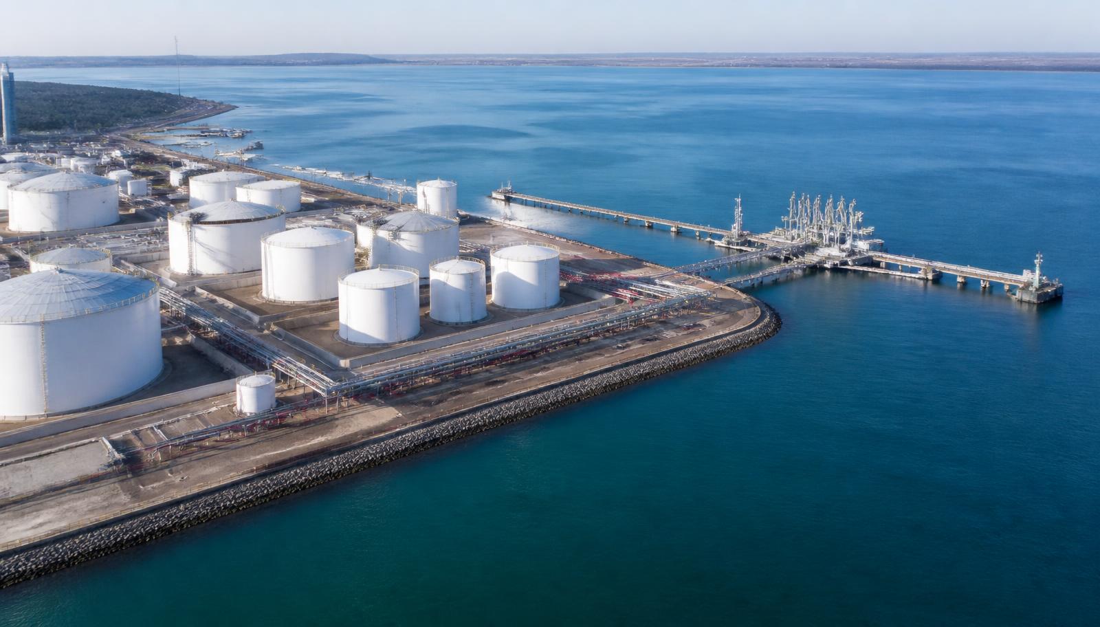 Aerial view of a coastal tank farm and loading jetty